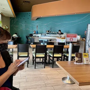 a woman wearing a face mask and looking at her phone