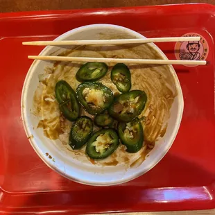 Half dollar sized jalapeño peppers in poke bowl