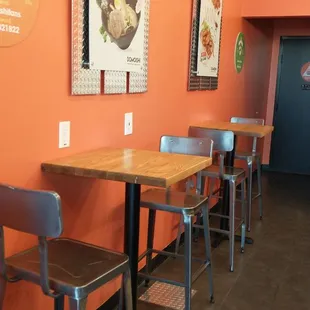 Orange wall and slim bistro chairs
