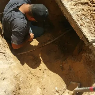 Trench being dug to pin point water leak.