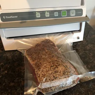 Brisket seasoned, rubbed, and getting vacuumed