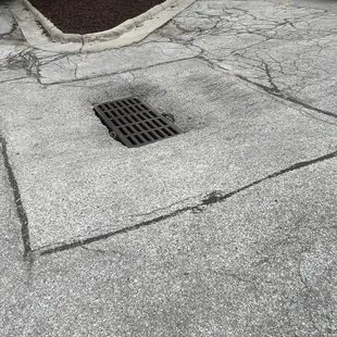 a drain in a parking lot