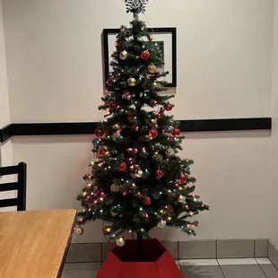 a decorated christmas tree in a corner