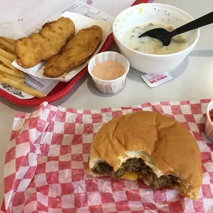 a hamburger and fries with dipping sauce
