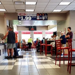 Entrance to the right, order counter the the left, television to the east end.