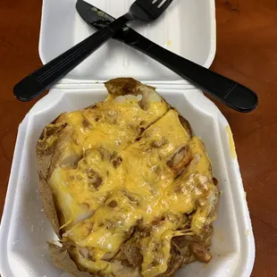 "Smothered?" I don't see smothered in chili. I see a dollop of chili and a topping of cheddar cheese.