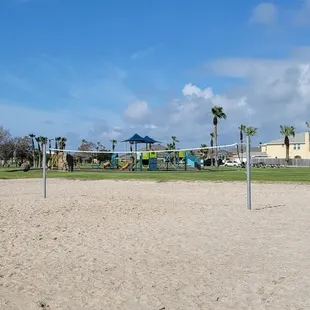 Beach Volleyball with playground in background