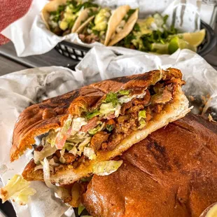 a chicken sandwich with a side of salad