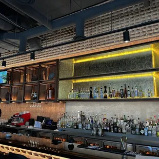 Full bar with a lit fancy gold leaf top shelf