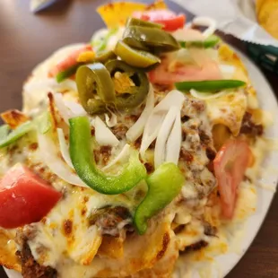 Loaded nachos. There are plenty of toppings.