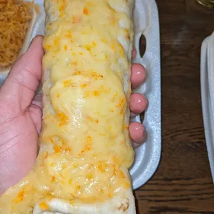 a person holding a burrito