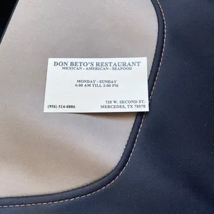 a business card on the back of a jacket