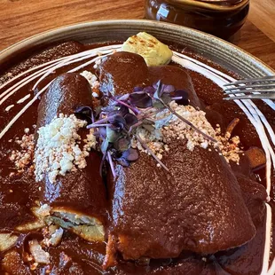 guajillo sauce enchiladas over carrots and potato's.