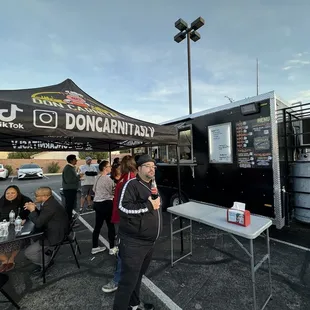 a man standing in front of a food truck