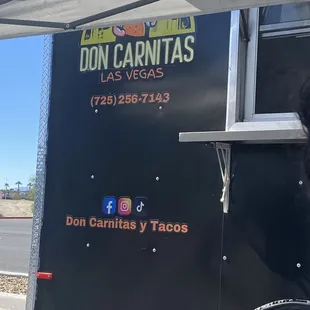 a dog standing in front of a food truck