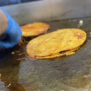 a person cooking food on a grill