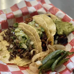 three tacos in a basket on a table