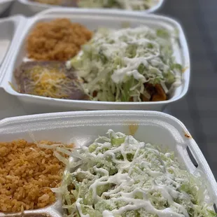 three takeout containers of mexican food