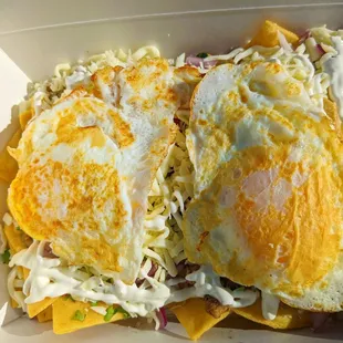 two fried eggs in a box