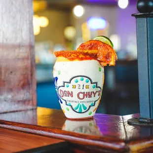 a drink with a garnish garnish