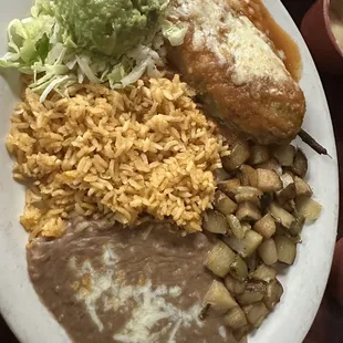 Chile Relleno, rice, beans, and potatoes