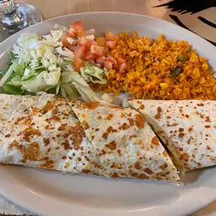 a burrito, rice and salad on a plate