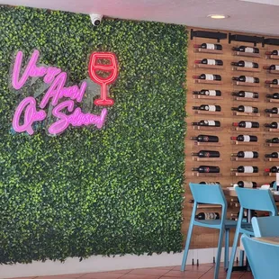 a restaurant with a wall of wine bottles