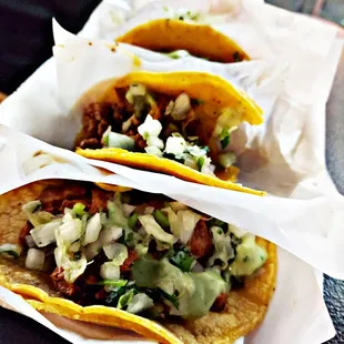 Marinated Pork Tacos (Al Pastor), and grilled steak tacos (Carne Asada).