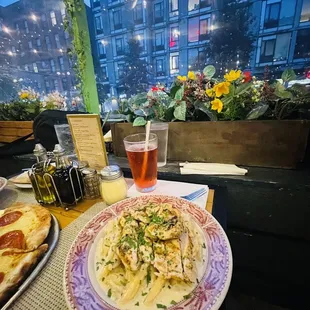 a plate of pasta and a glass of beer