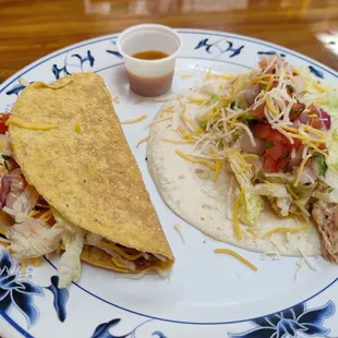 Ground beef taco (crunchy tortilla) and shredded chicken taco (soft tortilla)