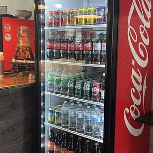 a display of coca colas and soft drinks