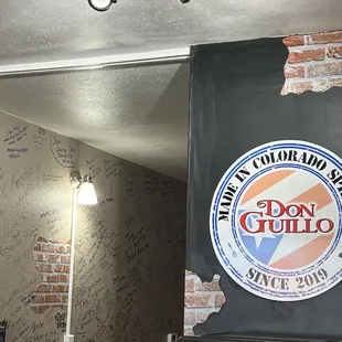 a sign on the wall of a restaurant