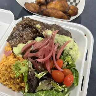Steak with rice and beans. Side of sweet plantains too. Delicious and big portions!
