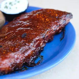 a plate of ribs and potatoes