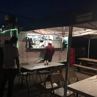a group of people standing around a food truck