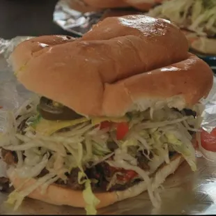 two sandwiches on tin foil