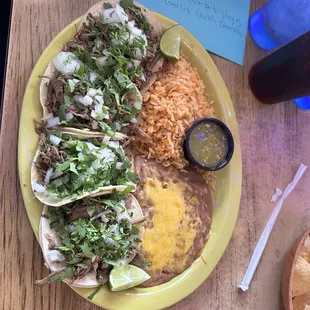 Shredded beef tacos rice and beans.