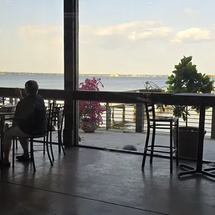 From indoors of the lake view and outside seating area. There is a dock for boaters.