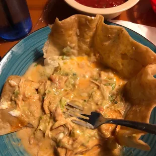 a plate of food and a bowl of salsa