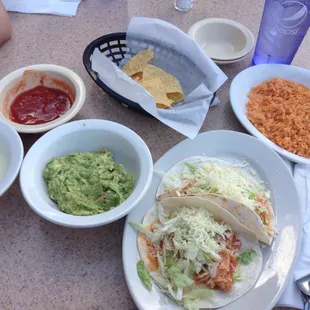 Chicken tacos, side of rice, large guacamole and cheese, regular free chips and salsa.