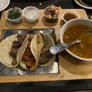 Tacos Don Jose with steak taco, Al pastor taco, and carnitas taco over a grilled cactus and poblano pepper with a side of charro bean soup.
