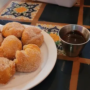 a plate of donuts and a cup of coffee