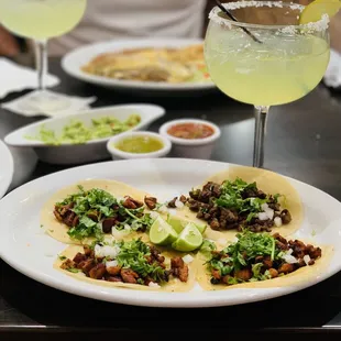 Pastor and carne asada tacos, guacamole and margaritas.