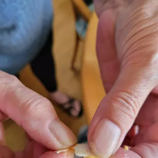 a person peeling a piece of food