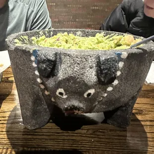 Fresh guacamole, that they make table-side, in this awesome pig bowl. Cute! Delicious!