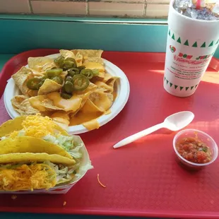 Large nachos, two tacos, and a medium drink.