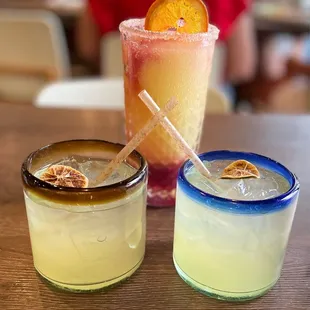 Two Happy Hour Margaritas crossing straws and a Sangriarita.