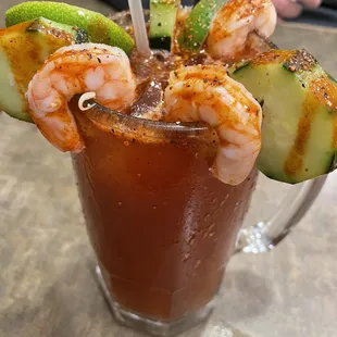 Michelada - shrimp and cucumbers with hot sauce and tajin on the rim