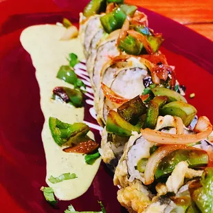 Ribeye Roll: Ribeye steak, Avocado, grill onion, cilantro, jalapeño, Oaxaca Cheese, Snow Crab, Tempura Style, Especial Chef Sauce.