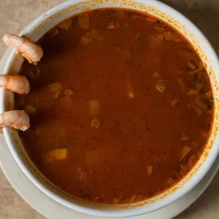 a bowl of soup with shrimp